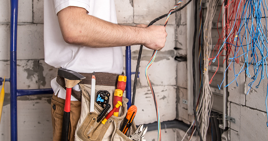 Electrician preparing and stripping wires during an installation
